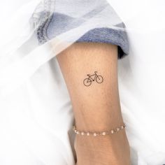 a person with a bike tattoo on their left leg and the word love written in it