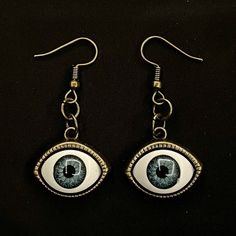 Please read descriptions thoroughly for sizes and materials.  This is a pair of earrings with eerily realistic blue resin eyeballs with a bronze bezel that seem to always be looking at you. They are a really fun and a little spooky! They are hung from standard hypoallergenic ear wires. Earrings are also available to be hung on 925 Sterling Silver ear wires, clip ons, 16-18mm Surgical Steel Hoops or 12-14mm Surgical Steel Hoops. Make sure to check out my shop for more hair pins, jewelry, earrings Novelty Blue Drop Earrings, Handmade Vintage Halloween Earrings, Vintage Handmade Halloween Earrings, Novelty Handmade Metal Jewelry, Novelty Metal Earrings With Ear Wire, Vintage Halloween Earrings As Gift, Handmade Metal Earrings For Halloween, Vintage Earrings For Halloween Gift, Blue Handmade Novelty Earrings