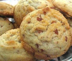 several cookies are stacked on top of each other in a glass dish with silverware