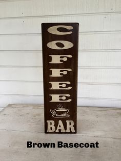 a wooden sign that says coffee bar on the side of a building with words above it