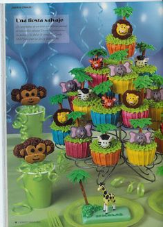 an advertisement for cupcakes with jungle animals on top and trees in the middle