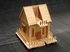 a small wooden house sitting on top of a table