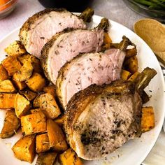 pork chops and roasted potatoes on a white plate