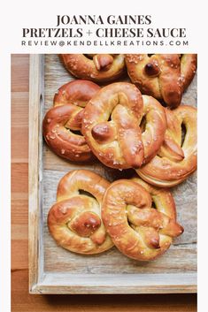 pretzels and cheese sauce in a wooden tray with text overlay that reads, joanna ganes pretzels and cheese sauce