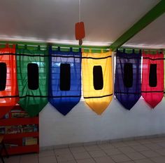 there are many different colored flags hanging from the ceiling