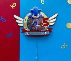 sonic the hedgehog cake topper on a blue and red background