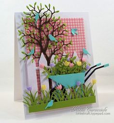 a card with flowers in a pot and a bird on the tree, next to it is a pink gingham background