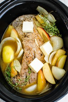 a slow cooker filled with meat and vegetables