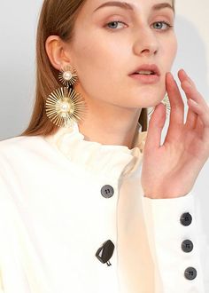 Indulge in luxury with our Sunburst Statement Earrings. The elegant sunburst shape, crafted from imitation pearls, adds a touch of sophistication to any outfit. This must-have piece of women's jewelry is perfect for those seeking to elevate their style game. Embrace the exquisite and make a statement with our drop earrings. 3"(8cm) drop 2 1/4" (5.5cm) width Post back Alloy/imitation pearl Women's earrings Item 470505 Pearl Statement Earrings, Unusual Earrings, Long Tassel Earrings, Bold Earrings, Dangle Hoop Earrings, Gold Statement Earrings, Heart Dangle Earrings, Vintage Pearl, Party Earrings