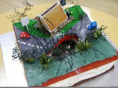 a cake that looks like it is made to look like a book with an image of a house on top