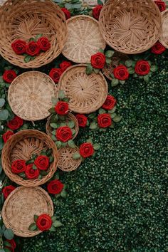 several baskets with red roses on them are arranged in the shape of a heart and surrounded by greenery