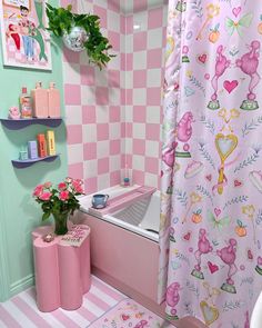 a bathroom with pink and green decor on the walls, shower curtain, toilet paper roll holder, rugs and shelves