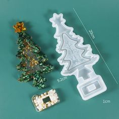 christmas tree shaped cookie cutters next to each other on a green surface with measurements