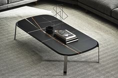 a coffee table sitting on top of a carpeted floor next to a gray couch