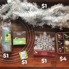 christmas ornaments and other holiday decorations are on the table with price tags for each ornament