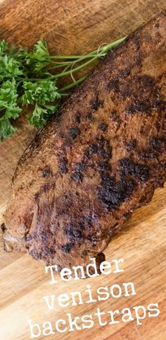 a steak on a cutting board with parsley next to it and the words tender venison backstraps