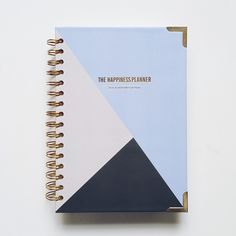 a spiral notebook with the words happiness planner written on it