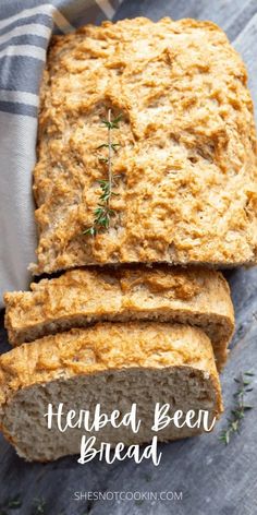 sliced loaf of homemade beer bread sitting on top of a wooden table