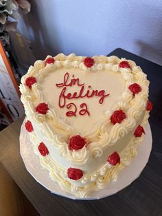 a heart - shaped cake with the words lindging on it is sitting on a table