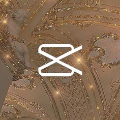 an abstract photo with the letter x on it's side and gold glitters in the background