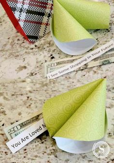 folded money sitting on top of a counter next to an origami fortune card