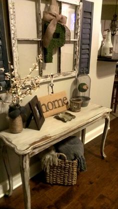 a white table sitting in front of a mirror on top of a wooden floor