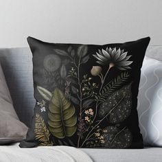 a black background with flowers and leaves throw pillow