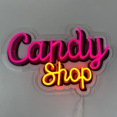 a neon sign that says candy shop