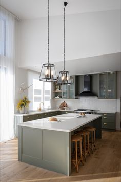 a large kitchen with an island in the middle