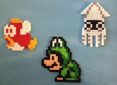 three pixel art magnets depicting mario and luigi in different poses on a blue surface