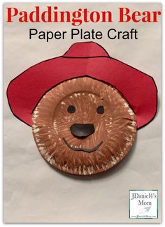 a paper plate with a red hat on it and the words paddington bear written in white