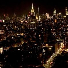 an aerial view of new york city at night from the top of the empire building