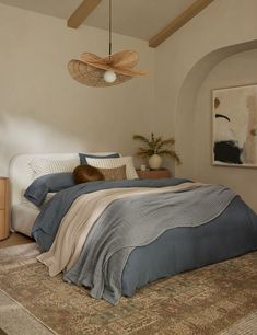 a bedroom with a bed, rugs and ceiling fan in it's corner