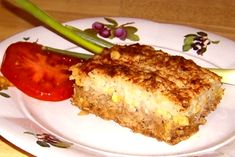 a piece of cake on a plate with tomatoes and celery next to it