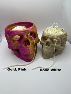 two different colored skulls sitting next to each other