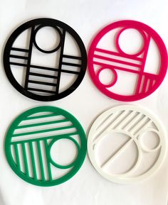 four circles with different designs on them sitting next to each other in front of a white background