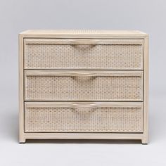 a white wicker dresser with three drawers