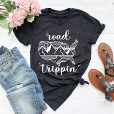 "Road Trip Shirt Hi! Welcome to my store, I'm delighted to see you here. My store's main goal is to provide you with premium everyday apparel with the best graphic t-shirts.  DESCRIPTION * Printed and shipped from the USA. * We use state of art printing on soft and quality shirts. * Different size options; crewneck, youth, women's v-neck, toddler, and baby size options.  * Effective customer service and expedited shipping.  * Solid colors are 100% airlume combed and ringspun cotton.  * Heather colors 52/48 cotton/polyester. * Shoulder taping. Side-seamed. Fitted at bicep. Tear-away label. 4.2 oz. SIZES AND COLORS:  * Please refer to the size charts for measurements before placing an order. * You can compare our numbers to one of your favorite shirts to make sure. * Unisex shirts are true t Short Sleeve Tops With Text Print For Adventure, Relaxed Fit Graphic Print Top For Adventure, Graphic Print Cotton Top For Outdoor Activities, Relaxed Fit Cotton Tops For Adventure, Adventure Graphic Cotton Tee, Adventure Graphic Cotton Tee Shirt, Cotton T-shirt With Letter Print For Adventure, Summer Adventure Tops With Short Sleeves, Cotton Adventure Shirt With Letter Print