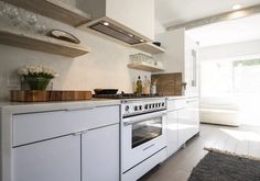 a white kitchen with an oven and counter tops