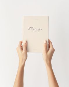 a person holding up a book with the word, planner written in cursive writing