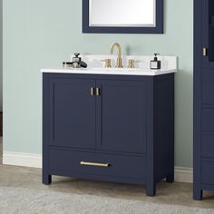 a bathroom vanity with two sinks and a large mirror above it, against a blue wall