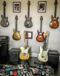 guitars and amps are lined up against the wall