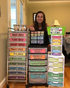 a woman standing in front of a stack of plastic containers filled with different types of labels