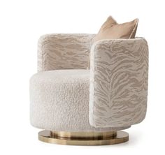 a white chair with a gold base and zebra print upholstered on the back