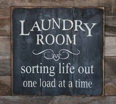 a wooden sign that says laundry room sorting life out one load at a time