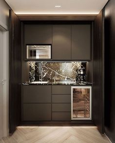 an empty kitchen with marble counter tops and dark cabinets