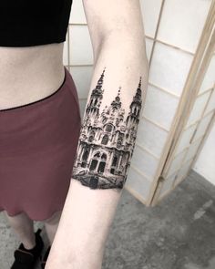 a woman's arm with a black and white photo of a building on it