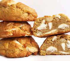 a stack of cookies with white frosting on them sitting next to each other in front of a white background