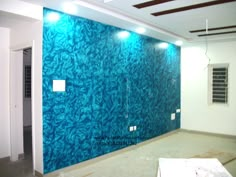 an empty room with blue wallpaper in the middle and white walls on both sides