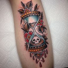 a tattoo with an hourglass and skull on it